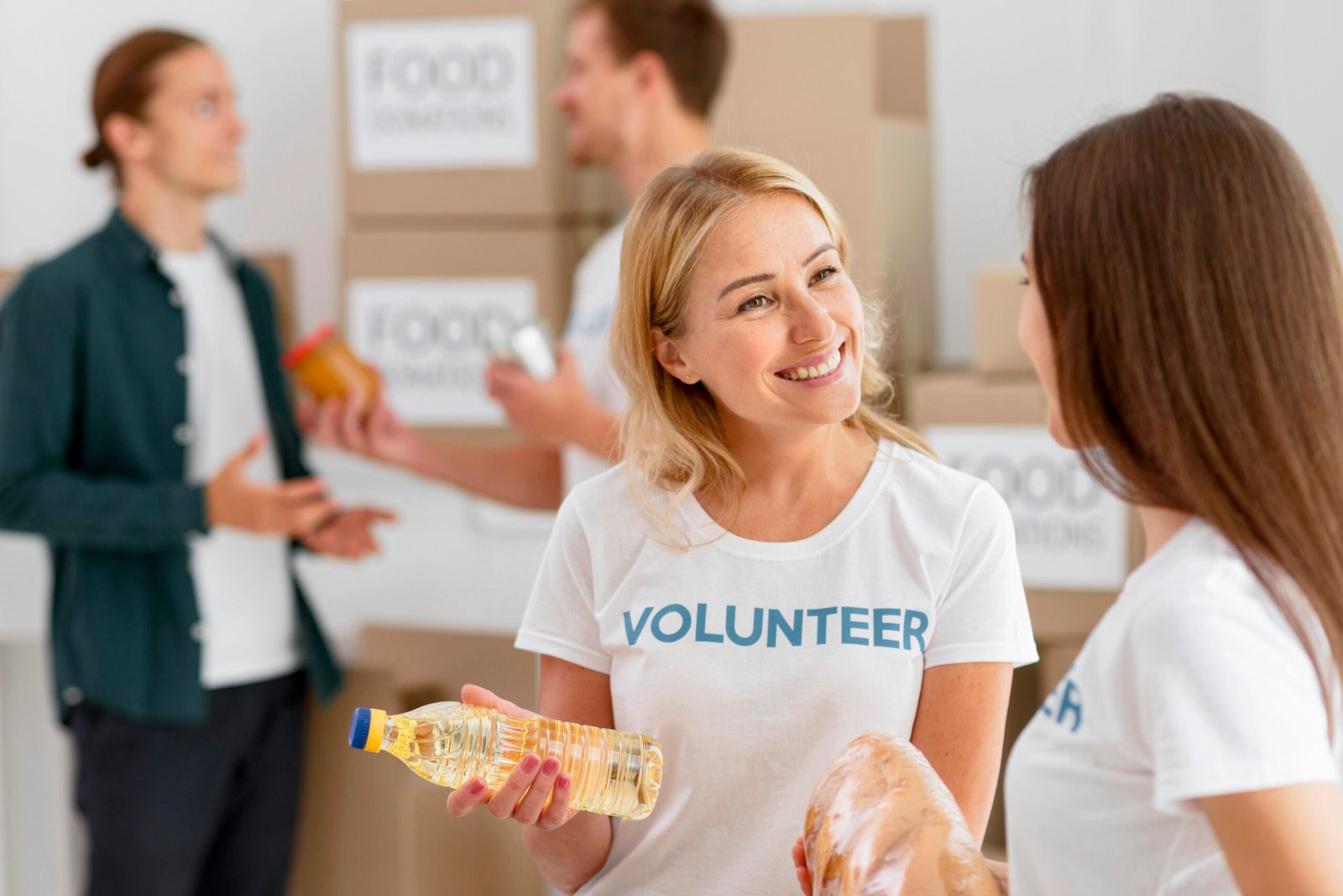 smiley volunteers preparing food provisions donation scaled